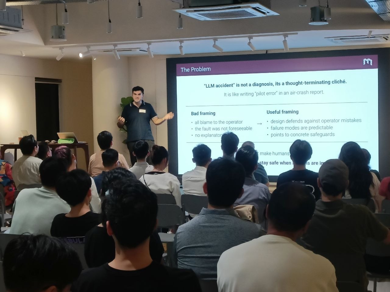 A speaker discusses AI safety with a seated audience at the Agentic Builders’ Collective.