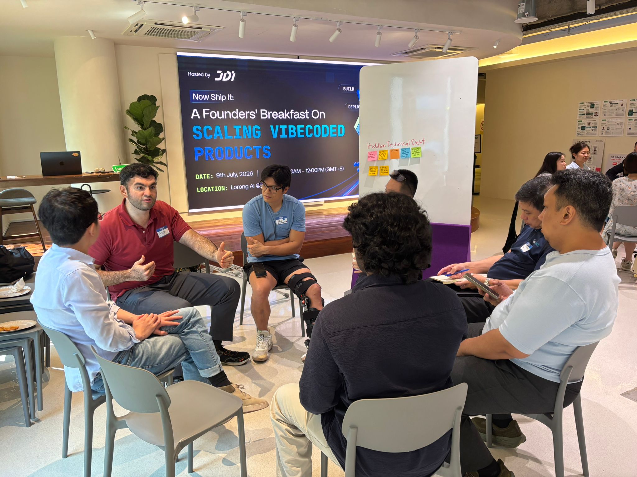 Founders exchange ideas in a small-group discussion about scaling AI-built products.